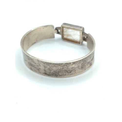 664 - Silver and rutilated quartz bracelet, marked 'silver' with fish skeleton stamp, inner diameter 59mm,... 