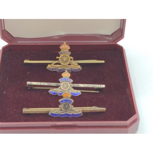 667 - Three Royal Artillery enamelled sweetheart brooches, including one marked silver