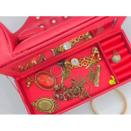 669 - Red sofa jewellery box with jewellery contents including Victorian shell shaped locket, necklaces, l... 