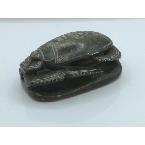 694 - Carved soapstone Egyptian scarab beetle, hieroglyphs to underside, length 10.2cm