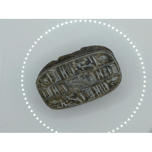 694 - Carved soapstone Egyptian scarab beetle, hieroglyphs to underside, length 10.2cm