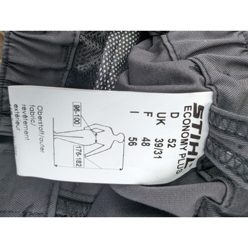 56 - Pair of Stihl chainsaw trousers (size 31-39 waist, 39 leg) appear unused. Together with Stihl chain ... 