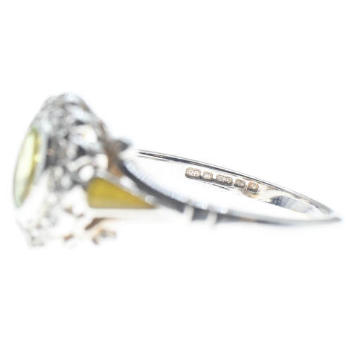 24 - Peridot and diamond cluster ring mounted on a 14ct white gold shank, peridot 6mm x 4mm, size N1/2, g... 