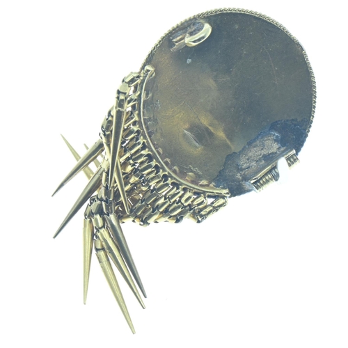 28 - Etruscan revival yellow metal fringed brooch, closed back set with foil backed rock crystal cabochon... 