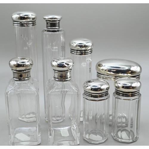 167 - Set of six silver lidded glass vanity bottles, maker's mark rubbed, London 1911, together with a sim... 