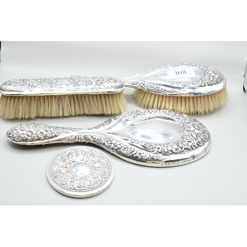 168 - Four silver mounted vanity / dressing table items, including: a circular handbag mirror by Carr's of... 