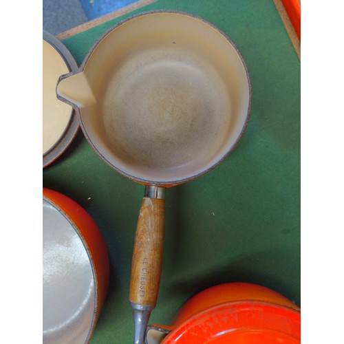 20 - Le Creuset set of 3 graduated saucepans with lids in orange