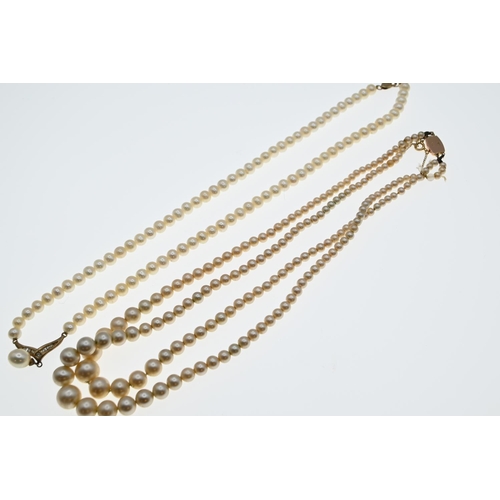 60A - String of matched cultured pearls with a 9ct gold clasp and central drop pearl suspended from a diam... 