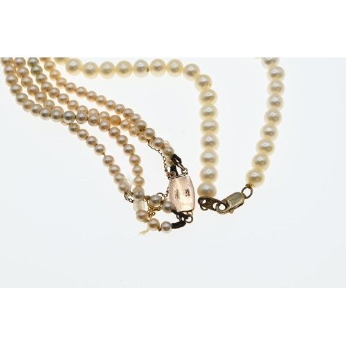 60A - String of matched cultured pearls with a 9ct gold clasp and central drop pearl suspended from a diam... 