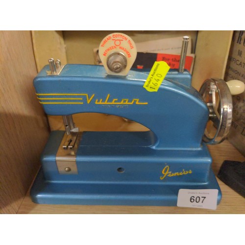 Child's Vulcan sewing machine & a students microscope.