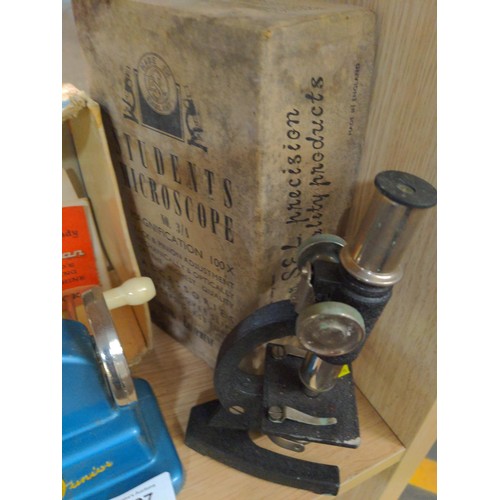 Child's Vulcan sewing machine & a students microscope.