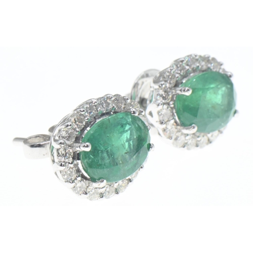 1027 - Pair of 18ct gold, emerald and diamond cluster earrings, length 18mm, gross weight 4.2 grams