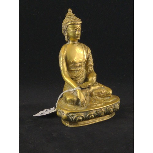 548A - Figure of Buddha, modelled seated with his hands in bhumisparsa mudra, height 17.8cm