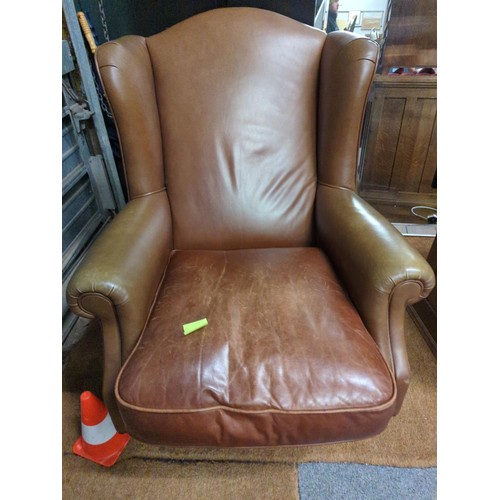 1177 - Laura Ashley 'Southwold' leather wing back arm chair. Has turned legs and front brass castors.