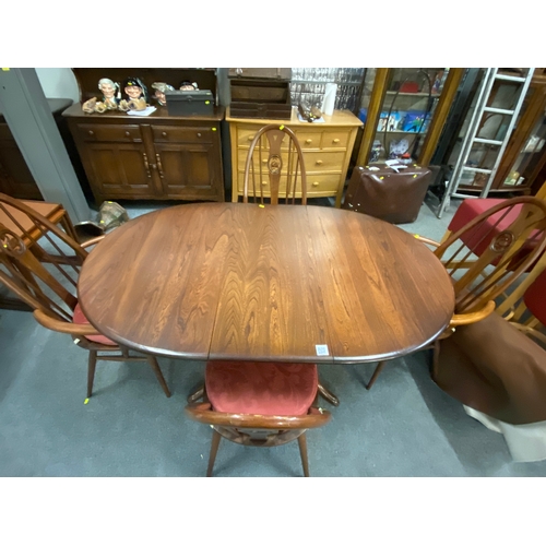 699 - Dark wood Ercol extending dining table with two dining chairs and two carver chairs. ( seat pads are... 