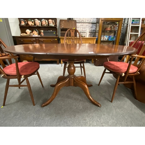 699 - Dark wood Ercol extending dining table with two dining chairs and two carver chairs. ( seat pads are... 