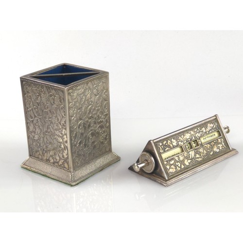 1020 - White plated metal perpetual desk calendar and pen holder.