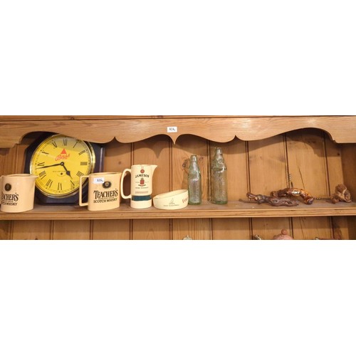 816 - Shelf of beweryana inc. Teacher's water jugs, Bass wall clock and rootwood corkscrews etc.