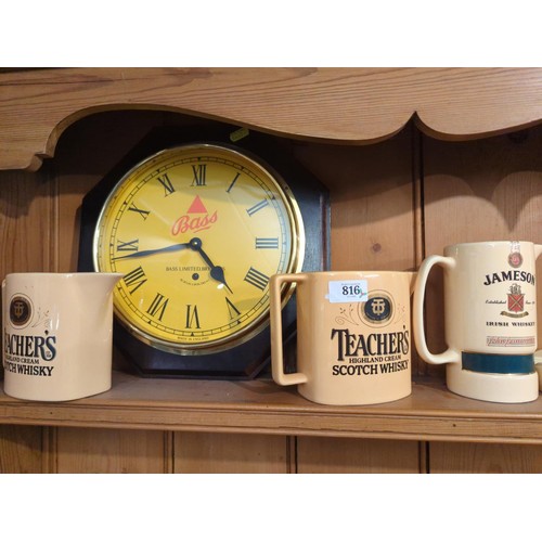 816 - Shelf of beweryana inc. Teacher's water jugs, Bass wall clock and rootwood corkscrews etc.