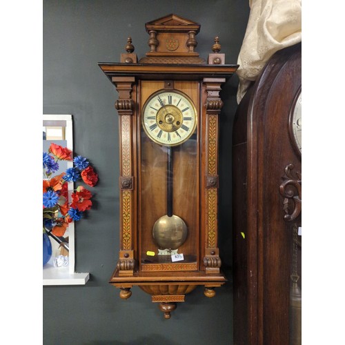 837 - Mahogany cased wall clock flanked with marquetry scrolled panels and a painted enamel and brass face... 