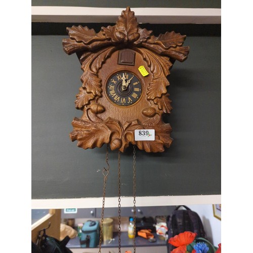 839 - Cuckoo clock with weights, 29cm high.