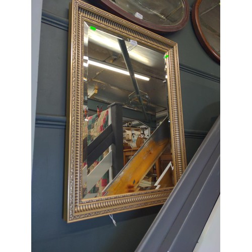 438 - Rectangle bevelled mirror in ornate gilt frame.W60 L84 CM