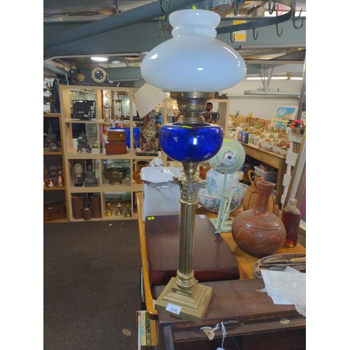 456 - Victorian oil lamp and glass globe with corinthian style base. H73.5 cm