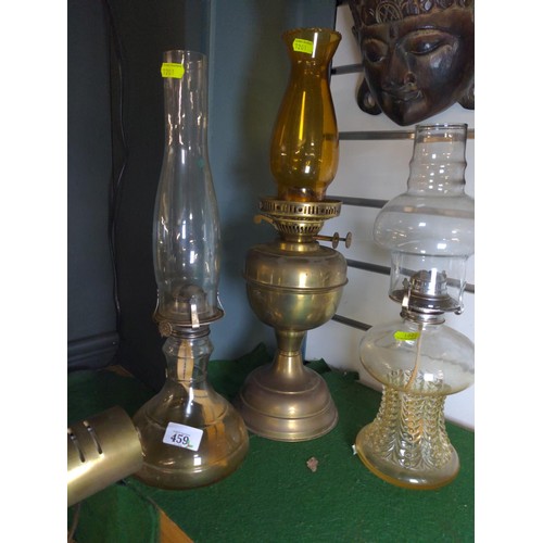 459 - Three vintage oil lamps, all with glass chimneys. Tallest 48.5 cm