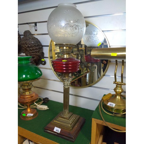 461 - Tall brass oil lamp with original glass and workings presented on a wooden plinth. H68 cm