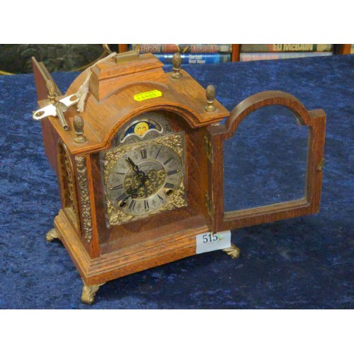 515 - Wood cased carriage style clock with brass detail to face and sun face.Wuba H26CM with key