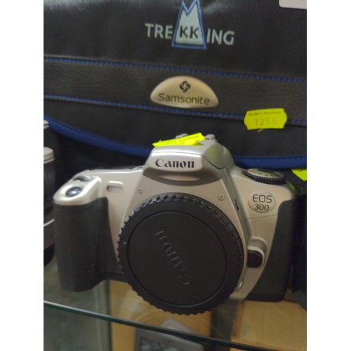 690 - Two Canon EOS 300 camera bodies one with motor battery pack, Canon 28-90mm zoom lens and large padde... 