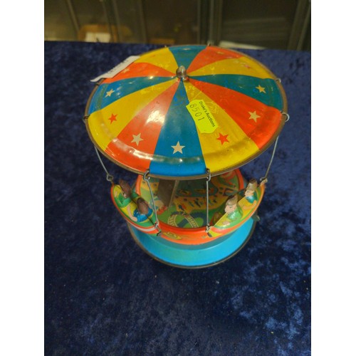 726 - Vintage tin plate flying rocket carousel, in working order, height approx. 17cm