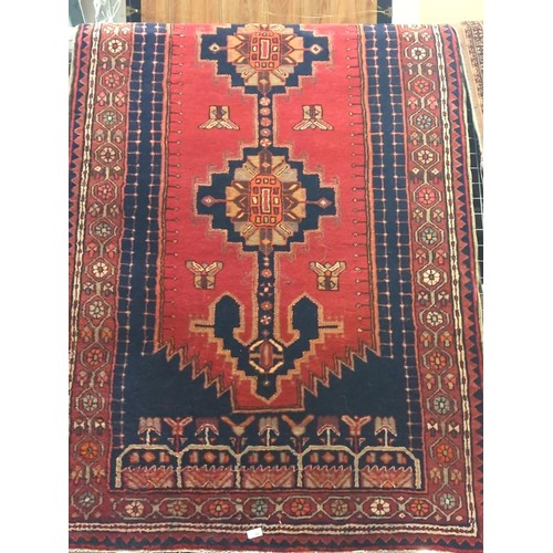 781 - 140 x 280 red and blacks aztec style rug with central design