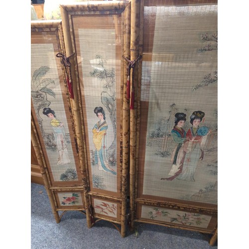 956 - Four panel bamboo screen painted with ladies. Length when open, 140cm x height 121cm.