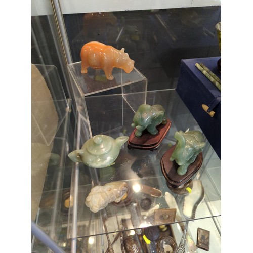 666 - Shelf of carved Jade, onyx plus other Eastern collectables in spinach jade bowls.