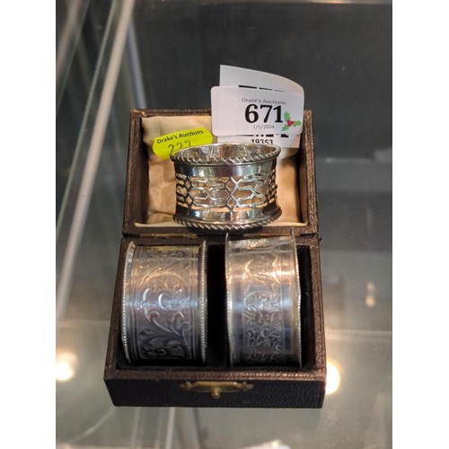 671 - Three silver napkin rings, various makers and dates, initialled or named, gross weight 66 grams... 