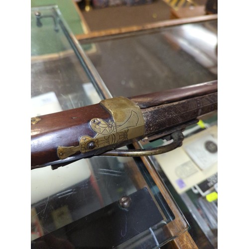 775 - Japanese matchlock rifle circa 1820 with inland brass scenes on barrel L. 135cm