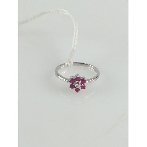 635 - Ruby and diamond flower head ring mounted on 9ct white gold. Size Q 1/2, gross weight 2.20g.