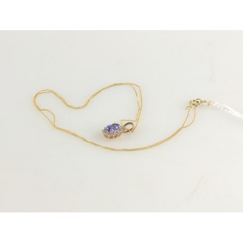 639 - Tanzanite and zircon cluster, 9ct gold pendant. With a 9ct gold chain, length 430mm. gross weight 1.... 