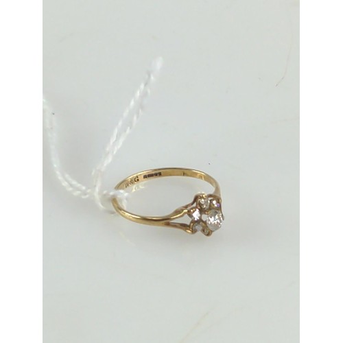 641 - 9ct gold and diamond flower head ring. Central stone approx. 3mm dia. Size M 1/2. Gross weight 1.6g