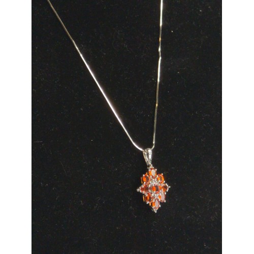 644A - 9ct white gold, orange garnet and diamonds set pendant on a 9ct white gold snake chain. Length 430mm... 