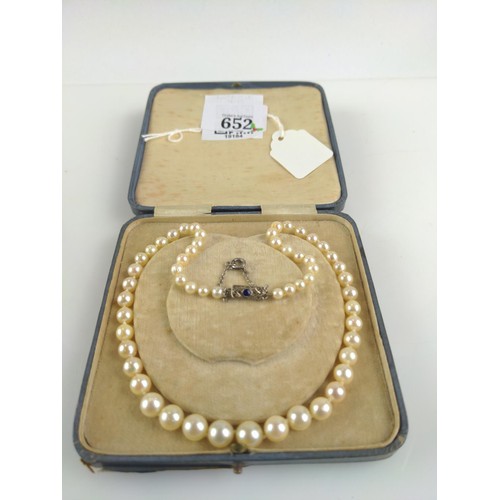 652 - String of graduated cultured pearls with a 9ct white gold clasp set with sapphire and diamond accent... 