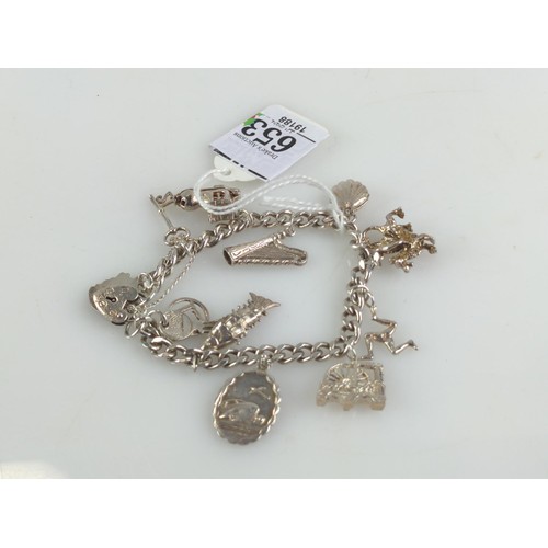 653 - Silver charm bracelet with 12 charms including a Georg Jensen St Christopher marked  GJ Lt... 