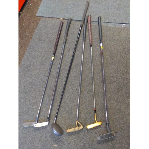 187 - 5 putters and a number 3 metal wood.