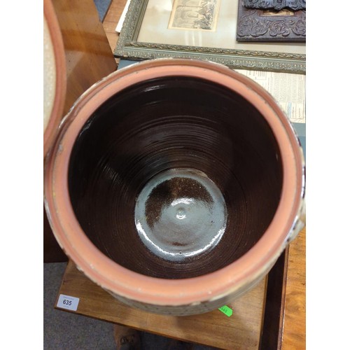 634 - Large terracotta glazed and lidded two handled storage jar. H33 cm (opening dia. 23 cm)