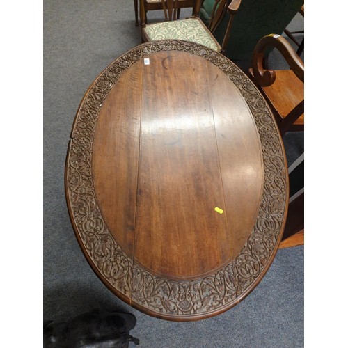 653 - Carved oak two leaf folding oval table. W113 D78 H53 cm approx