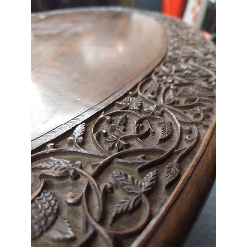 653 - Carved oak two leaf folding oval table. W113 D78 H53 cm approx