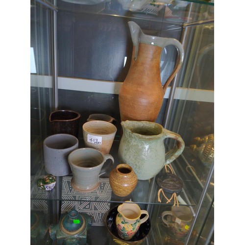 417 - Four shelves of mostly studio pottery