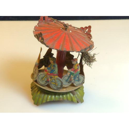 457C - Ges Gesch German penny tin toy carousel with cyclists. (canopy loose.)