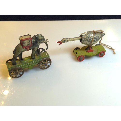 457D - Distler tin penny toy goose and elephant on wheels